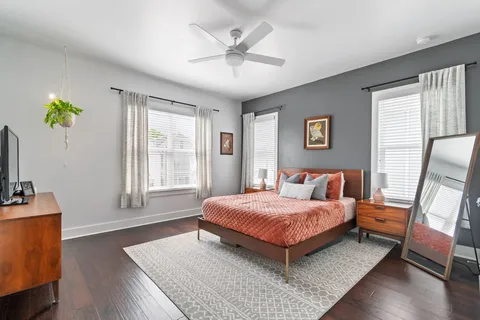 a bedroom with a bed and wooden floor