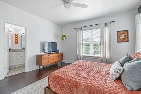 a bedroom with a bed and a window