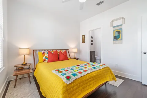 a bedroom with a bed and wooden floor