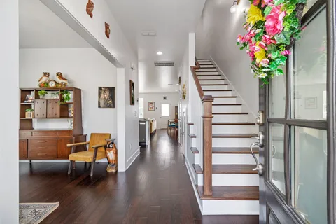 a view of entryway with stairs and wooden floor