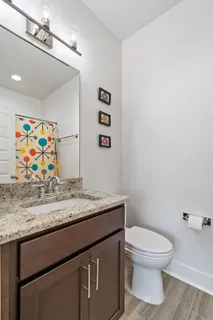 a bathroom with a toilet a sink and mirror