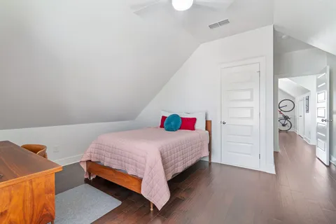 a bedroom with a bed and a dresser