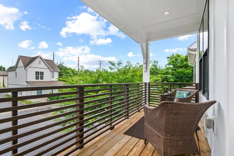 a view of two chairs in a balcony