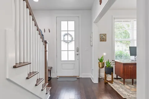 a view of an entryway with wooden floor and a potted plant