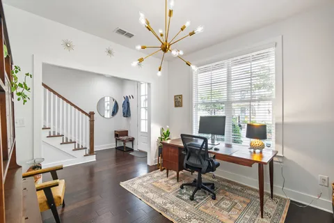 a workspace with wooden floor and a window