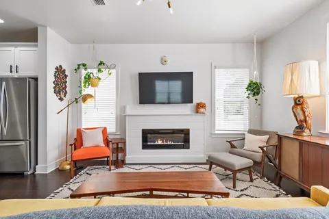 a living room with furniture fireplace and flat screen tv