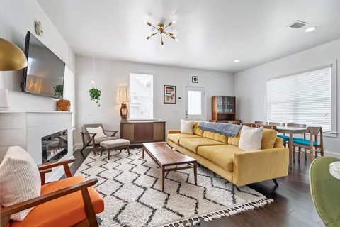 a living room with furniture and a fireplace