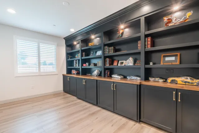 a room with a bookshelf and a window