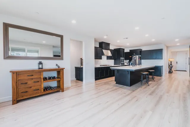 a kitchen with stainless steel appliances granite countertop a sink and a refrigerator