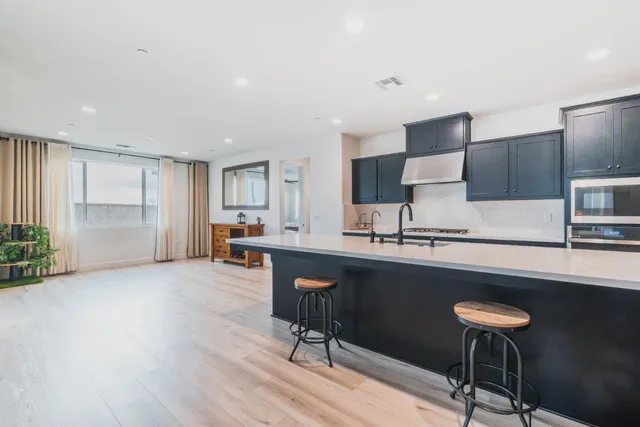 a stove top oven sitting inside of a kitchen