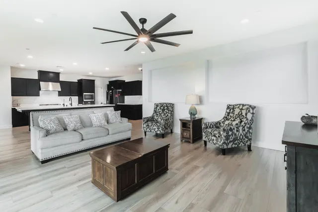 a bedroom with a large bed and a chandelier