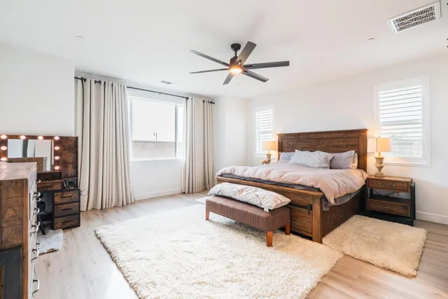 a spacious bedroom with a bed and a walk in closet