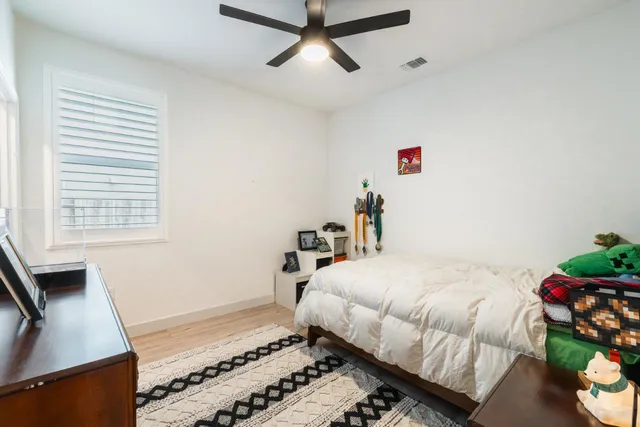 a bedroom with a bed and a window