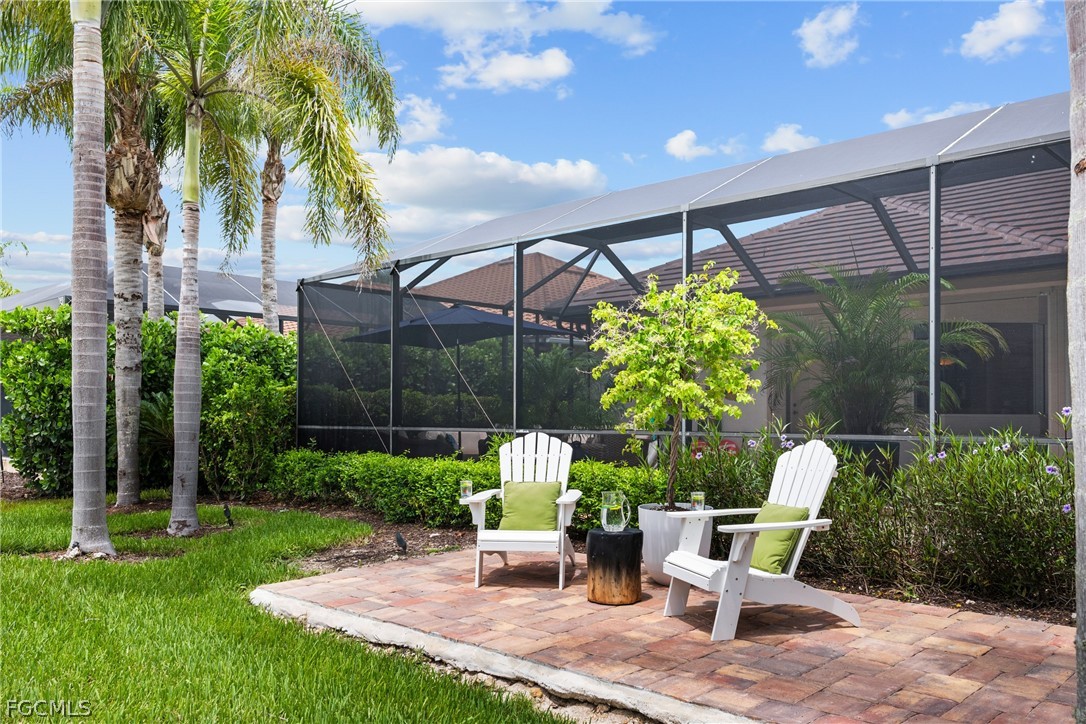 9383 Slate Court Naples, FL 34120 - Photo 22 of 28 a view of a chair and table in backyard of the house