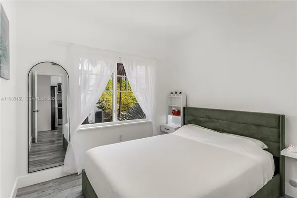 a bedroom with a bed and a cabinets
