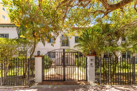 a view of a yard with plants and trees