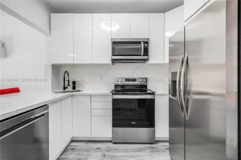 a kitchen with a stainless steel appliances and cabinets