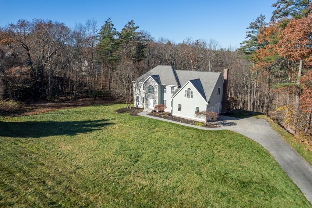 41 Mockingbird Hill Road Windham, NH 03087 - Photo 2 of 36 a view of a small house with a big yard and large trees