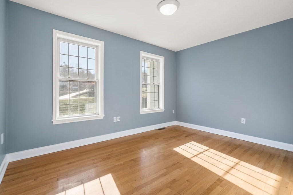 41 Mockingbird Hill Road Windham, NH 03087 - Photo 21 of 36 a view of an empty room with wooden floor and a window