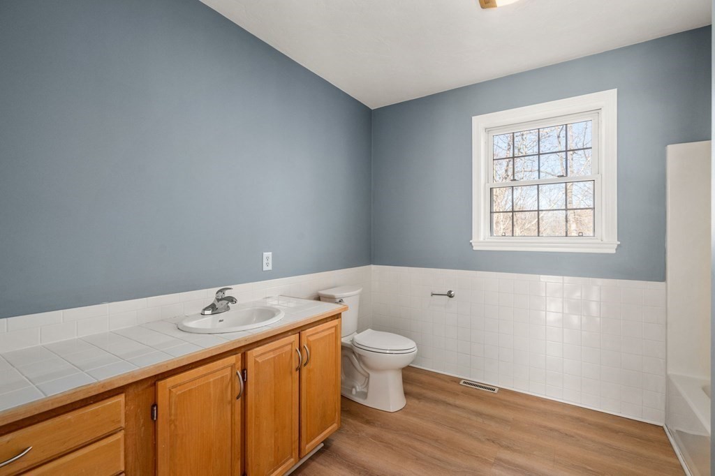 41 Mockingbird Hill Road Windham, NH 03087 - Photo 22 of 36 a bathroom with a sink and a large mirror