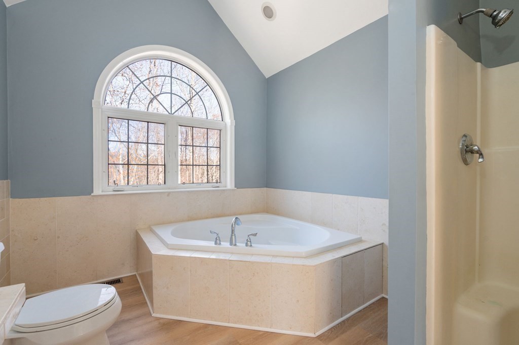 41 Mockingbird Hill Road Windham, NH 03087 - Photo 27 of 36 a white bath tub sitting next to a toilet