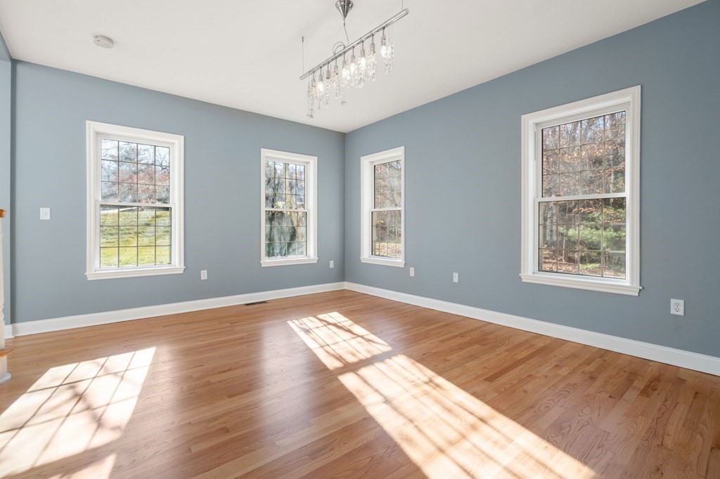41 Mockingbird Hill Road Windham, NH 03087 - Photo 6 of 36 a view of an empty room with wooden floor and a window