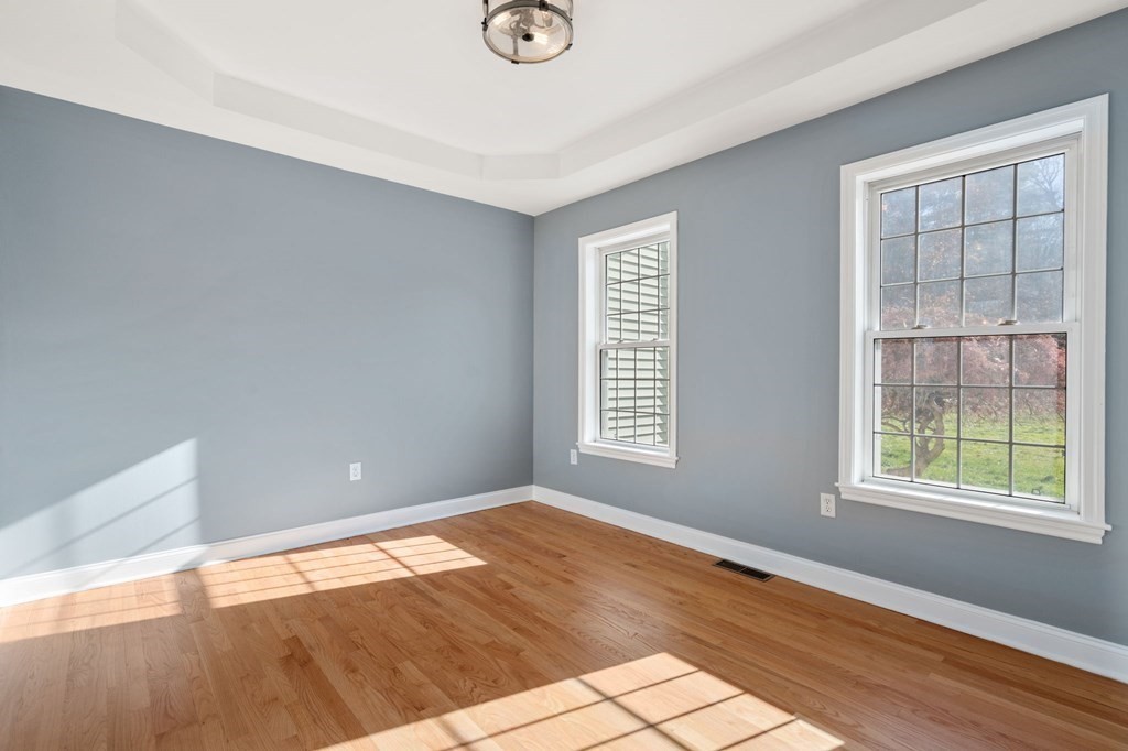 41 Mockingbird Hill Road Windham, NH 03087 - Photo 8 of 36 an empty room with wooden floor and windows