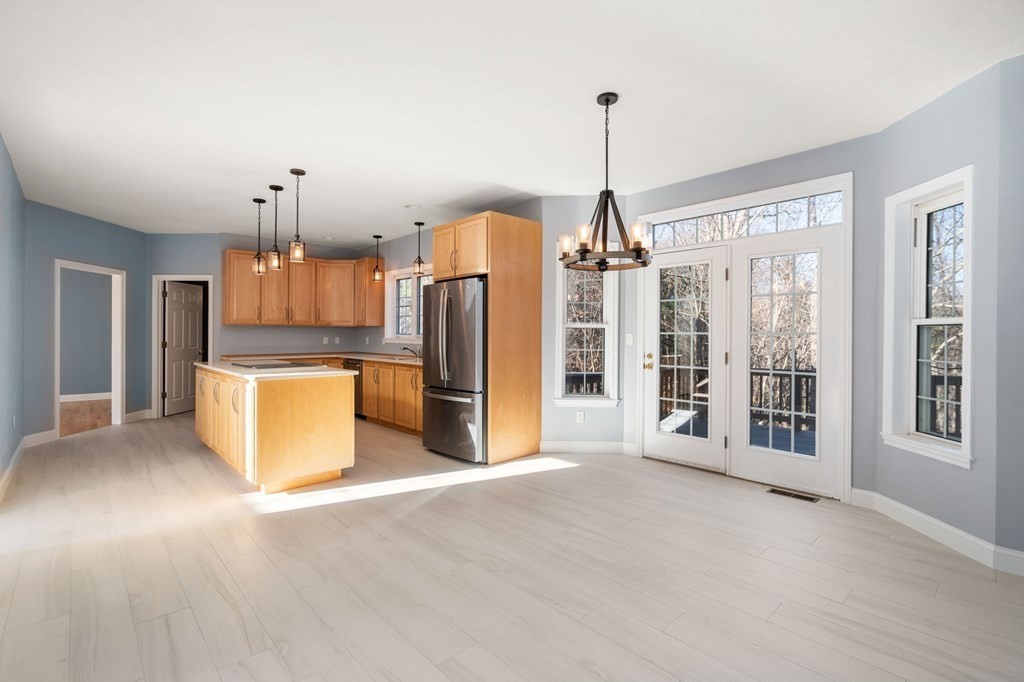 41 Mockingbird Hill Road Windham, NH 03087 - Photo 9 of 36 a view of a kitchen with refrigerator and wooden floor