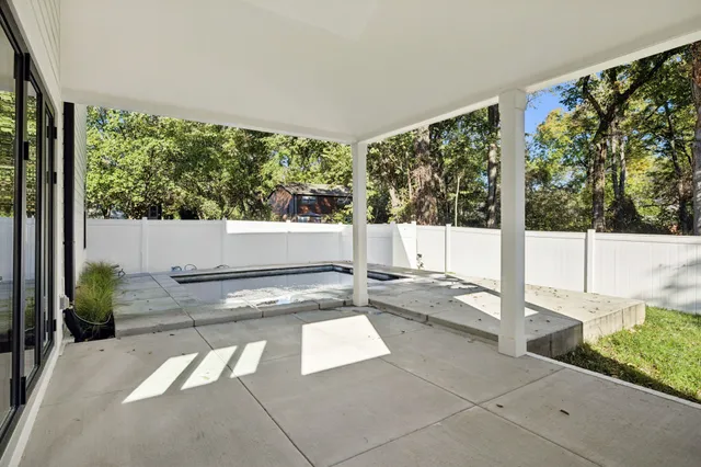 a view of a swimming pool with a patio and yard