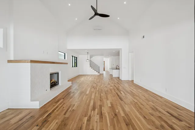 a open kitchen with kitchen island white cabinets and stainless steel appliances