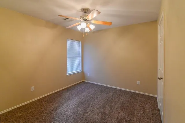en view of a chandelier fan in a room
