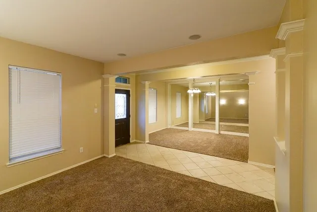 a large kitchen with a refrigerator a sink dishwasher a dining table and chairs