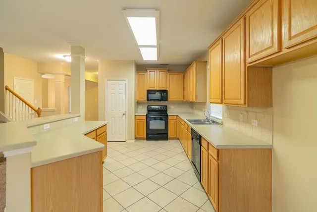a view of a kitchen with a sink and a large window