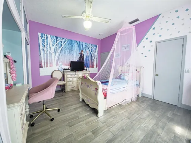 a bedroom with a bed and a chair