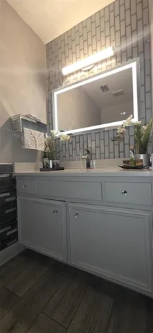 a bathroom with a sink and a mirror