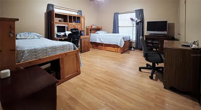 a bedroom with furniture and a flat screen tv
