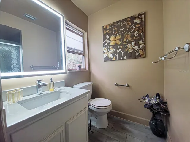 a bathroom with a sink toilet and a mirror