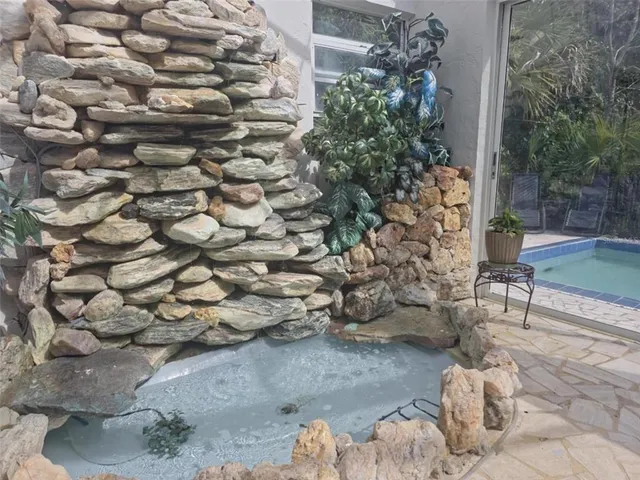 a backyard of a house with table and chairs