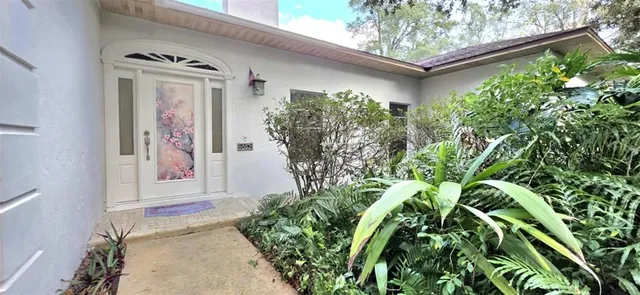 a view of a house with a flower garden