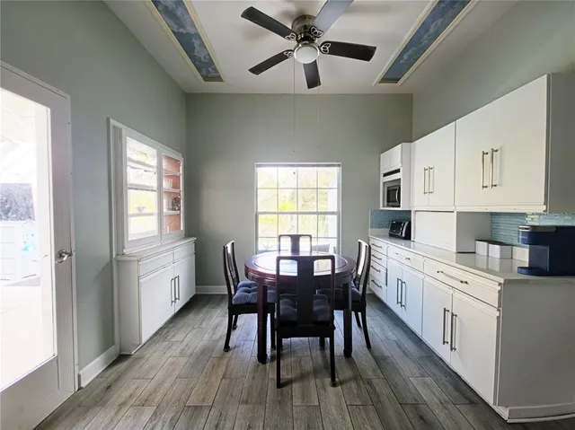 a kitchen with granite countertop white cabinets and stainless steel appliances