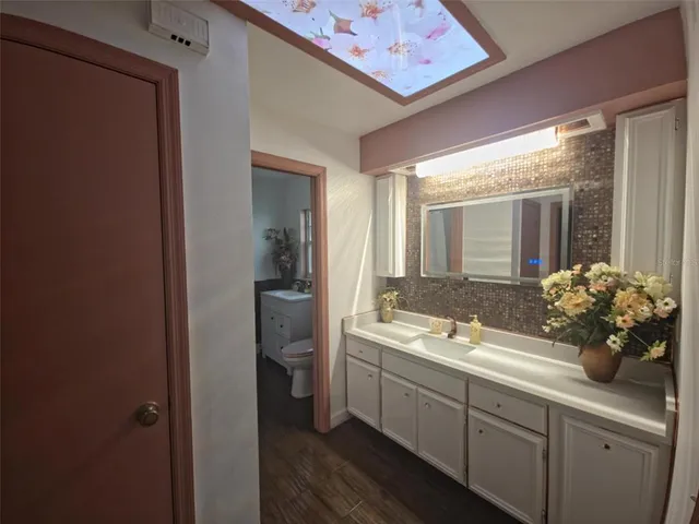 a spacious bathroom with a granite countertop sink mirror and a