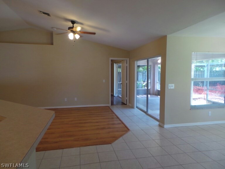 17448 Lee Road Fort Myers, FL 33967 - Photo 2 of 20 an empty room with kitchen view and windows