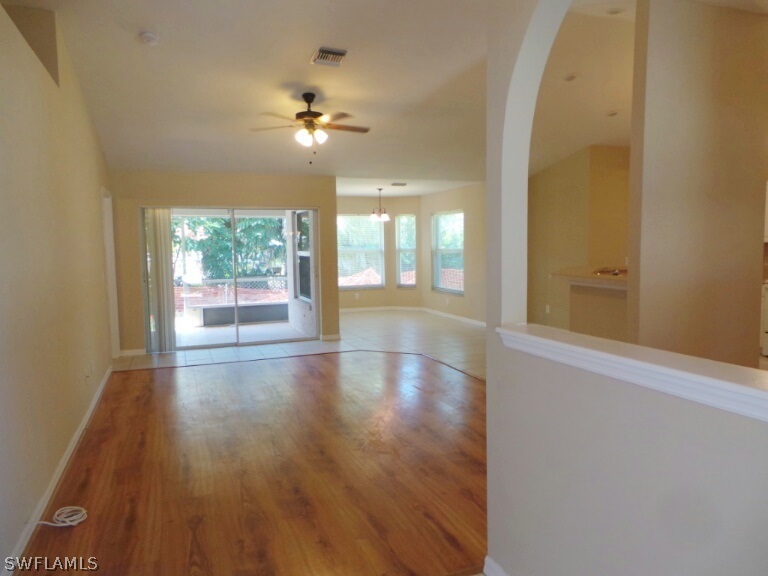 17448 Lee Road Fort Myers, FL 33967 - Photo 3 of 20 an empty room with wooden floor and windows