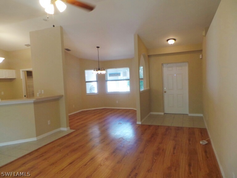17448 Lee Road Fort Myers, FL 33967 - Photo 6 of 20 an empty room with wooden floor and windows