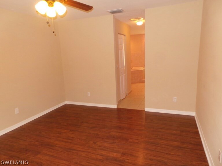 17448 Lee Road Fort Myers, FL 33967 - Photo 10 of 20 a view of an empty room with a chandelier fan