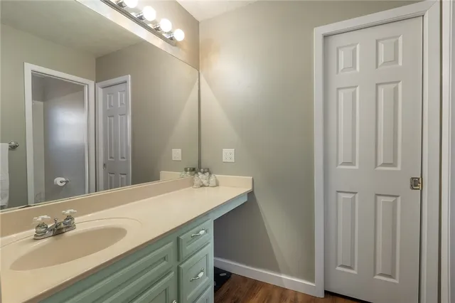 a bathroom with a double vanity sink and a mirror