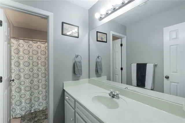 a bathroom with a sink vanity and a mirror