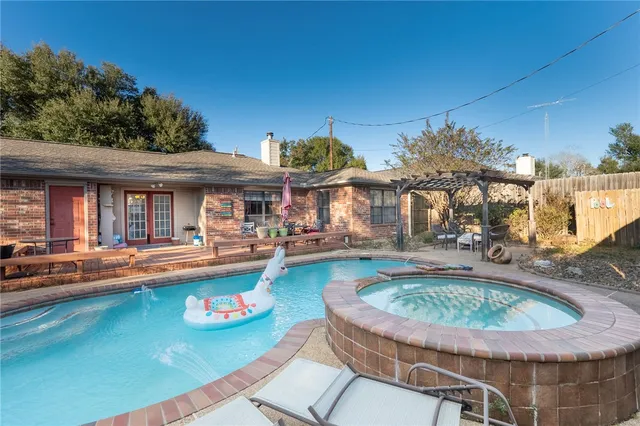 a view of a house with swimming pool and sitting area