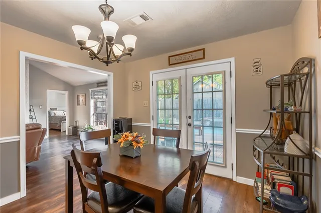 a view of a dining room with furniture wooden floor and chandelier