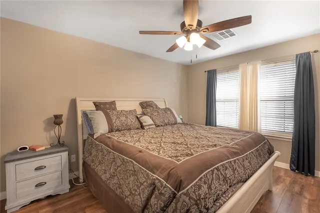 a bed sitting in a bedroom next to a window